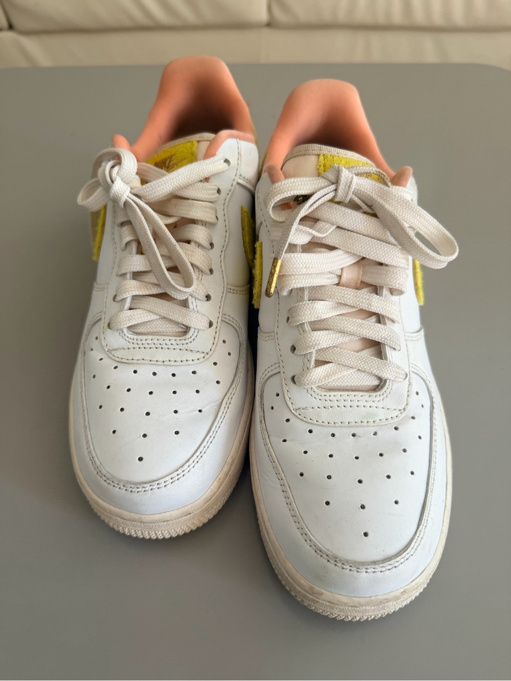 Nike White Sneakers with Peach Lining and Yellow Accent